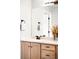 Well-lit bathroom vanity featuring wood cabinets, a white countertop and brushed bronze hardware at 9481 Longstone Dr, Parker, CO 80134
