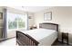 Inviting bedroom with a large window, a cozy queen bed and lots of natural light at 9481 Longstone Dr, Parker, CO 80134