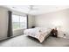 Inviting bedroom with plush carpeting, ceiling fan and a window to the backyard at 9481 Longstone Dr, Parker, CO 80134