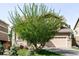Home exterior with a large green tree in the yard providing shade and curb appeal at 9481 Longstone Dr, Parker, CO 80134