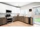 Modern kitchen featuring stainless steel appliances, granite countertops, and white cabinetry at 9481 Longstone Dr, Parker, CO 80134