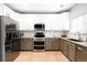 Bright kitchen with stainless steel appliances, granite countertops, and ample cabinet space at 9481 Longstone Dr, Parker, CO 80134