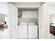 Laundry closet with washer, dryer, and overhead storage at 9481 Longstone Dr, Parker, CO 80134