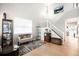 Bright living room with a staircase, decor shelving, and hardwood floors at 9481 Longstone Dr, Parker, CO 80134