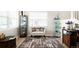 Bright living room with a staircase, decor shelving, and hardwood floors at 9481 Longstone Dr, Parker, CO 80134