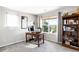 Bright office space featuring a large window, wooden desk, and built-in bookcase at 9481 Longstone Dr, Parker, CO 80134