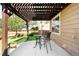 Pergola-covered patio with outdoor dining area at 9481 Longstone Dr, Parker, CO 80134