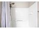 Clean bathroom with an updated shower featuring white tiled walls at 9481 Longstone Dr, Parker, CO 80134