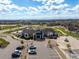 Aerial view of the community clubhouse, pool, parking, and surrounding neighborhood at 27110 E Fremont Pl, Aurora, CO 80016