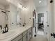 Bathroom featuring double sinks, neutral-toned cabinets, and modern black fixtures at 27110 E Fremont Pl, Aurora, CO 80016