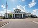 Exterior shot of the community clubhouse, featuring an American flag and ample parking at 27110 E Fremont Pl, Aurora, CO 80016