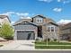 Charming two-story home featuring stone accents, a gray color scheme, and a well-manicured lawn at 27110 E Fremont Pl, Aurora, CO 80016