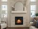 Close up of a modern fireplace with tile surround, mantle, and bright windows on either side at 27110 E Fremont Pl, Aurora, CO 80016