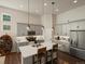 Modern kitchen with stainless steel appliances, gray cabinets, island with seating, and pendant lighting at 27110 E Fremont Pl, Aurora, CO 80016