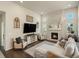 Cozy living room with a fireplace, large windows, and lots of natural light at 27110 E Fremont Pl, Aurora, CO 80016