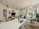 Open concept living space with a large kitchen island, fireplace, and bright dining area at 27110 E Fremont Pl, Aurora, CO 80016