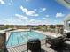 View of the community pool area, showing the pool, lounge chairs, and surrounding residential area at 27110 E Fremont Pl, Aurora, CO 80016