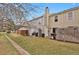 Large backyard featuring a fenced-in patio area, green grass, and plenty of space for outdoor activities at 8879 W Floyd Ave, Lakewood, CO 80227