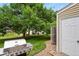 The outdoor kitchen is highlighted by a stainless steel BBQ grill and lush green space for gatherings at 8879 W Floyd Ave, Lakewood, CO 80227