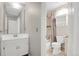 Well-lit bathroom featuring a modern vanity, a convenient toilet, and a shower/tub combo with tiled walls at 8879 W Floyd Ave, Lakewood, CO 80227