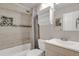 Updated bathroom showcasing a tiled shower/tub, modern vanity, and stylish accents for a refreshing experience at 8879 W Floyd Ave, Lakewood, CO 80227