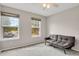 Sunlit bedroom with large windows, neutral walls, and a comfortable futon sofa for relaxing and unwinding at 8879 W Floyd Ave, Lakewood, CO 80227