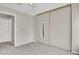 Simple bedroom with a closet, plush carpet, and natural lighting from the windows for comfort and relaxation at 8879 W Floyd Ave, Lakewood, CO 80227