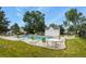 Relax by the community pool with ample seating, surrounded by lush greenery on a beautiful day at 8879 W Floyd Ave, Lakewood, CO 80227