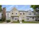 Charming townhome featuring tan siding, complemented by well-maintained landscaping and a welcoming entryway at 8879 W Floyd Ave, Lakewood, CO 80227