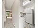 Bright kitchen features white cabinetry and appliances, seamlessly connecting to the living space at 8879 W Floyd Ave, Lakewood, CO 80227