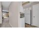 Galley kitchen showcases modern, white appliances, cabinets and view into an open living room with fireplace at 8879 W Floyd Ave, Lakewood, CO 80227