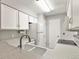 Well-maintained kitchen with white cabinetry, sleek countertops, and modern appliances for a functional cooking space at 8879 W Floyd Ave, Lakewood, CO 80227