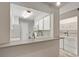 Convenient laundry area next to kitchen with white washer, dryer, and upper cabinets at 8879 W Floyd Ave, Lakewood, CO 80227