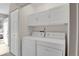 Convenient laundry room is complete with white cabinets for extra storage space and a washer/dryer set at 8879 W Floyd Ave, Lakewood, CO 80227