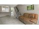 Relaxing living room featuring plush carpeting, an adjacent staircase, and a comfortable sofa at 8879 W Floyd Ave, Lakewood, CO 80227