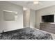The primary bedroom features soft carpeting, a ceiling fan and an integrated entertainment center at 8879 W Floyd Ave, Lakewood, CO 80227