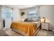 Cozy bedroom with carpet, large windows, neutral color scheme, and side tables with lamps at 6494 W 85Th Ave, Arvada, CO 80003