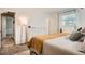 Bedroom with a white dresser, bedside lamps, a window with blinds, and neutral colored carpet at 6494 W 85Th Ave, Arvada, CO 80003