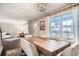 Elegant dining room featuring a large wooden table, stylish chairs, and lots of natural light at 6494 W 85Th Ave, Arvada, CO 80003