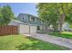 Attractive home with a two-car garage, blue siding, a front porch, and a manicured lawn at 6494 W 85Th Ave, Arvada, CO 80003