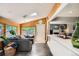 Living area featuring wood paneling, tile floors, and a large window overlooking a green backyard at 6494 W 85Th Ave, Arvada, CO 80003