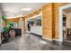 Bright living area with wood paneling, tile floors, a view of the kitchen, and a large plant at 6494 W 85Th Ave, Arvada, CO 80003