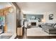 Bright living room with a white fireplace, ample seating, and a view of an adjacent room at 6494 W 85Th Ave, Arvada, CO 80003