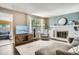 Cozy living room with a fireplace, a large window, and comfortable seating at 6494 W 85Th Ave, Arvada, CO 80003