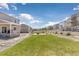 Large, well-maintained backyard with a stone fire pit area and landscaped features at 42741 Ivydel Cir, Elizabeth, CO 80107
