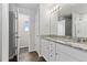 Bathroom features a double vanity with granite countertop and tiled floor at 42741 Ivydel Cir, Elizabeth, CO 80107