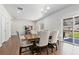 Open dining area with a wooden table, comfortable chairs, and a view of the living room and outdoor patio at 42741 Ivydel Cir, Elizabeth, CO 80107