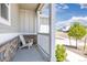 Cozy covered front porch features a white chair, stone accents, and a welcoming ambiance at 42741 Ivydel Cir, Elizabeth, CO 80107