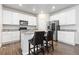 Modern kitchen features white cabinets, granite countertops, stainless steel appliances, and a breakfast bar with seating at 42741 Ivydel Cir, Elizabeth, CO 80107