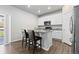 Stylish kitchen with white cabinets, granite countertops, stainless steel appliances, and a breakfast bar at 42741 Ivydel Cir, Elizabeth, CO 80107